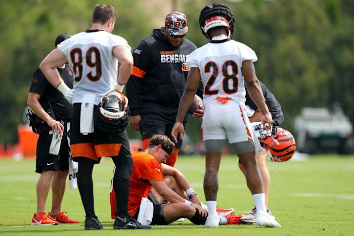 July 27, 2023; Cincinnati, OH, USA; Cincinnati Bengals quarterback Joe Burrow (9) suffers an injury on this scramble play during Cincinnati Bengals training camp practice, Thursday, July 27, 2023, at the practice fields next to Paycor Stadium in Cincinnati. Mandatory Credit: Kareem Elgazzar-USA TODAY NETWORK
