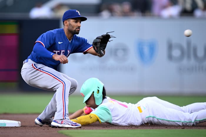 San Diego Padres second baseman Ha-seong Kim, right, steals second base ahead of the throw to Texas Rangers second baseman Marcus Semien during the first inning at Petco Park Friday night.