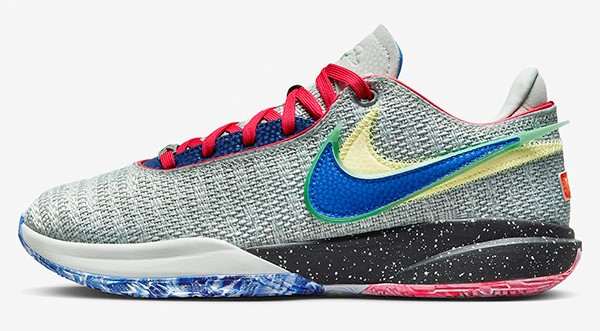 Side view of a grey and blue Nike LeBron basketball shoe.