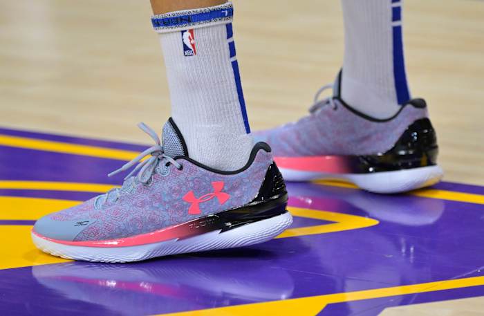 Side view of Stephen Curry's purple and pink Under Armour shoes.