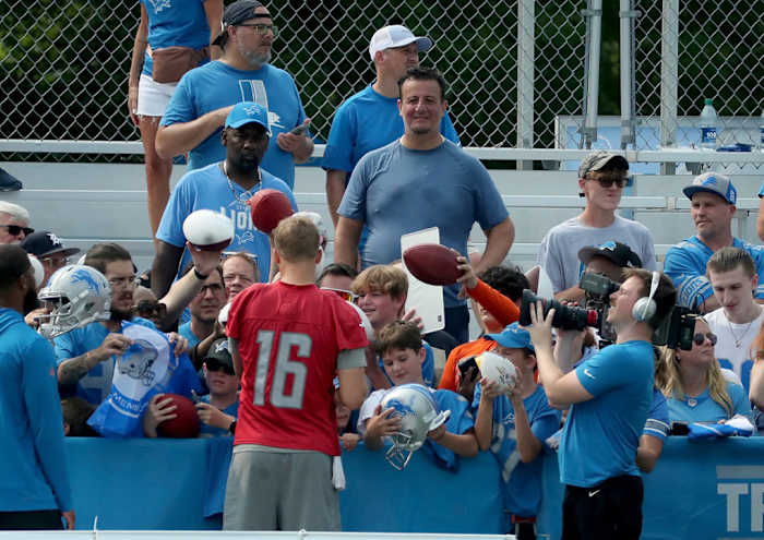 Detroit Lions quarterback Jared Goff signs autographs at training camp.