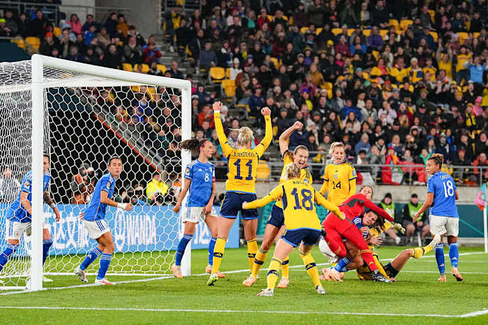 Sweden celebrates a goal against Italy near the net at the Women's World Cup.