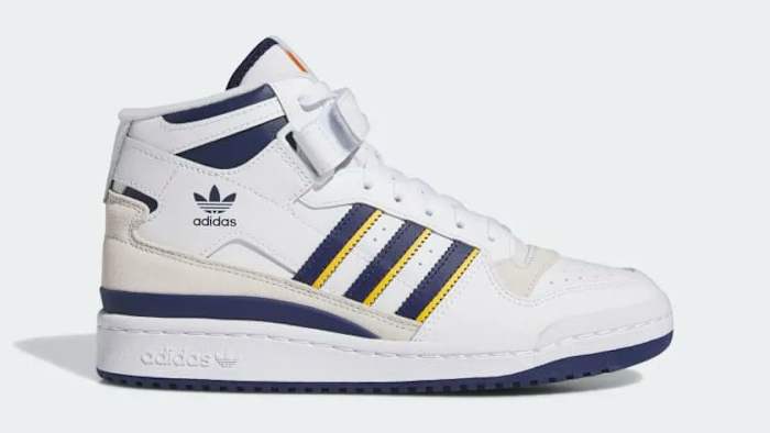 Side view of a white and navy adidas shoe.