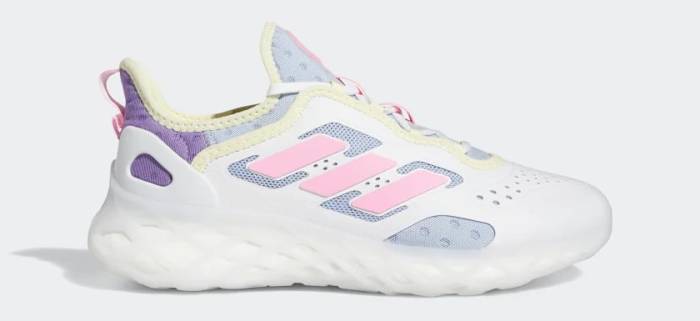 Side view of a white and pink adidas shoe.