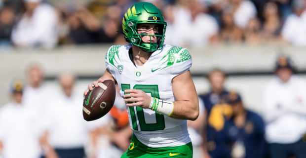 Oregon Ducks quarterback Bo Nix attempts a pass during a college football game.