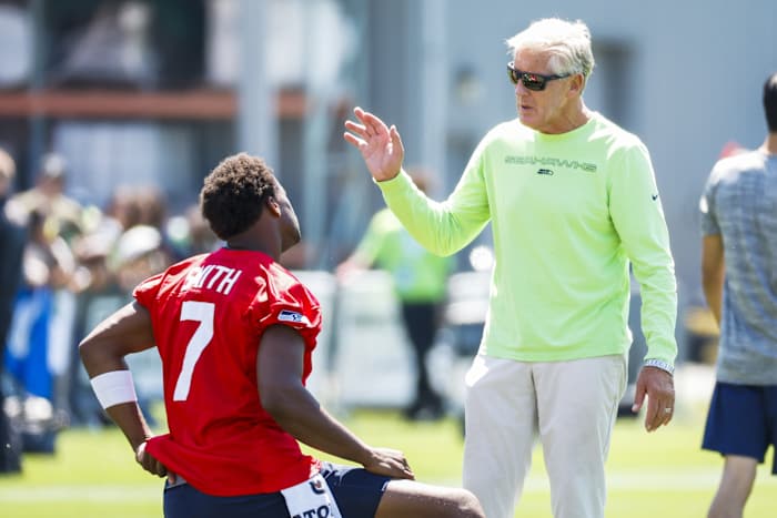 Seattle quarterback Geno Smith and coach Pete Carroll at training camp.