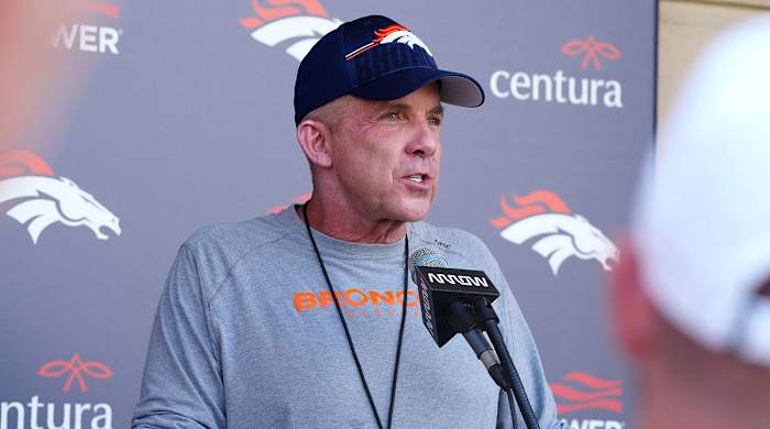 Broncos coach Sean Payton at a podium during training camp
