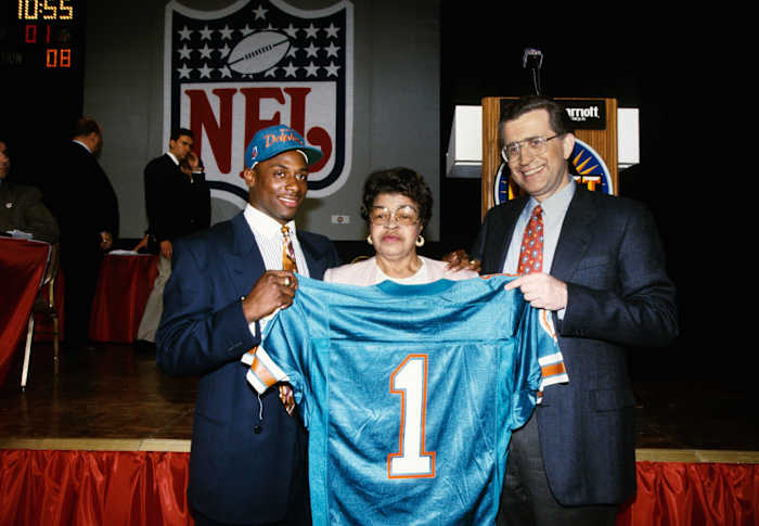 Troy Vincent standing with a Miami Dolphins jersey during the NFL Draft (Credit: RVR Photos-USA TODAY Sports)