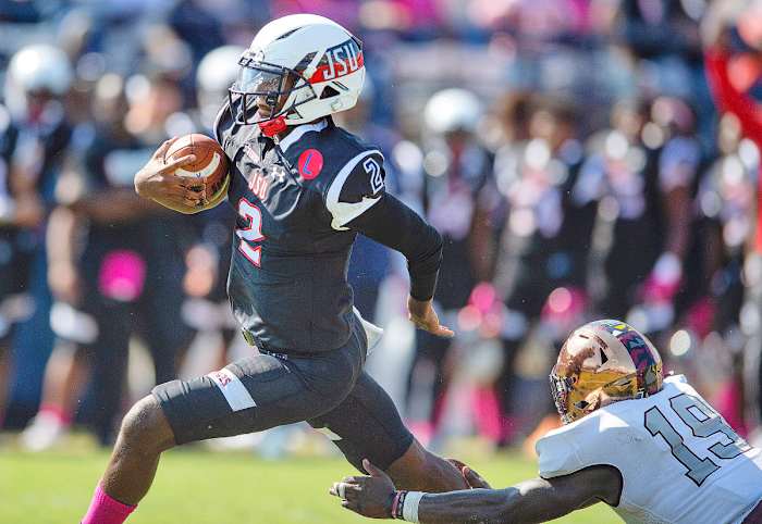 Jackson State QB Shedeur Sanders runs past a defender during a 2021 game