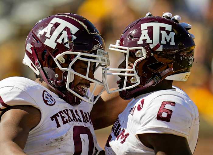 Oct 16, 2021; Columbia, Missouri, USA; Texas A&M Aggies running back Devon Achane (6) celebrates with wide receiver Ainias Smith (0) after scoring a touchdown against the Missouri Tigers during the second half at Faurot Field at Memorial Stadium. Mandatory Credit: Jay Biggerstaff-USA TODAY Sports