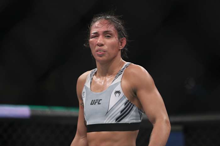 Taila Santos (blue gloves) during the fight against Valentina Shevchenko (red gloves) during UFC 275 at Singapore Indoor Stadium.