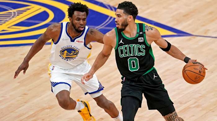Jayson Tatum dribbles around Andrew Wiggins