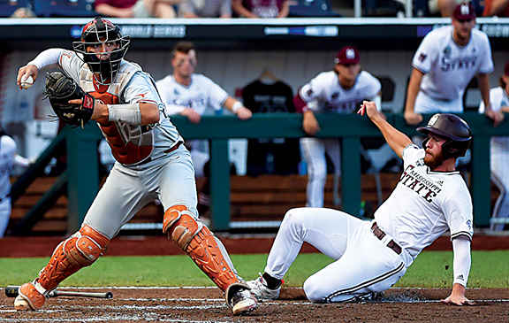 Texas Longhorns catcher Silas Ardoin (4) forces out Mississippi State Bulldogs catcher Luke Hancock (20) at home in the sixth inning at TD Ameritrade Park.