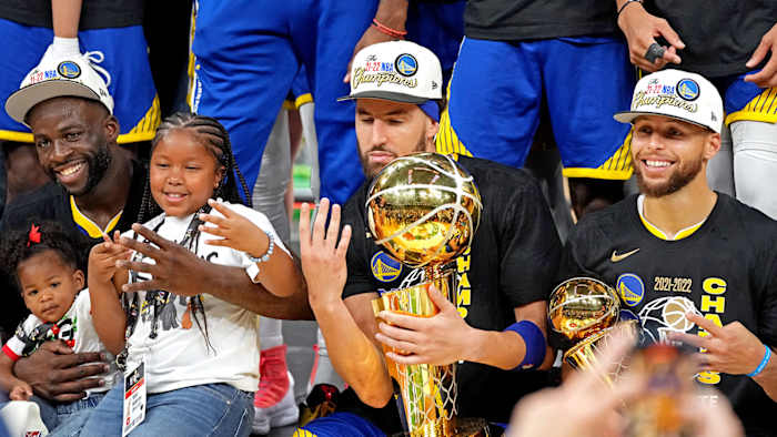 Golden State Warriors forward Draymond Green (23), guard Klay Thompson (11) and guard Stephen Curry (30) celebrates after beating the Boston Celtics in game six of the 2022 NBA Finals.