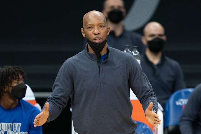 Sam Cassell stands on the sidelines.