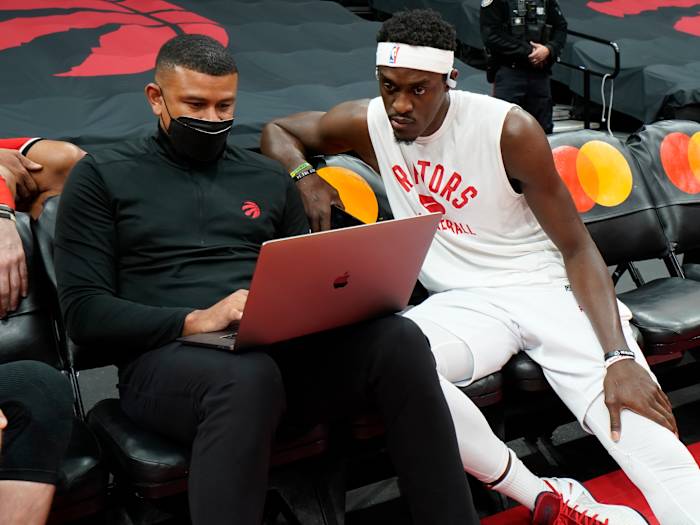 Toronto Raptors forward Pascal Siakam (right) reviews a play with assistant coach Earl Watson before a game against the Chicago Bulls at Scotiabank Arena.