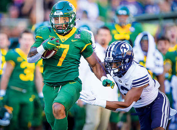 Baylor Bears running back Abram Smith (7) runs for a first down as Brigham Young Cougars defensive back Malik Moore (12) chases during the second half at McLane Stadium.