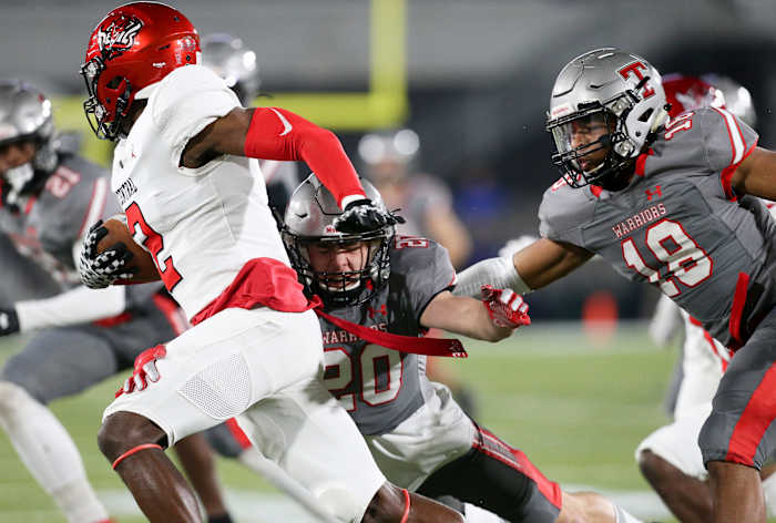 Thompson linebacker Kendall Franklin LB (20) and Thompson linebacker Seth Hampton (18) work to tackle Central wide receiver Karmello English (2) during the 7A state championship game in Birmingham Wednesday, Dec. 1, 2021. [Staff Photo/Gary Cosby Jr] 7a Championship Central Vs Thompson