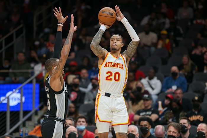 Atlanta Hawks forward John Collins (20) shoots over San Antonio Spurs guard Dejounte Murray (5) in the second half at State Farm Arena.
