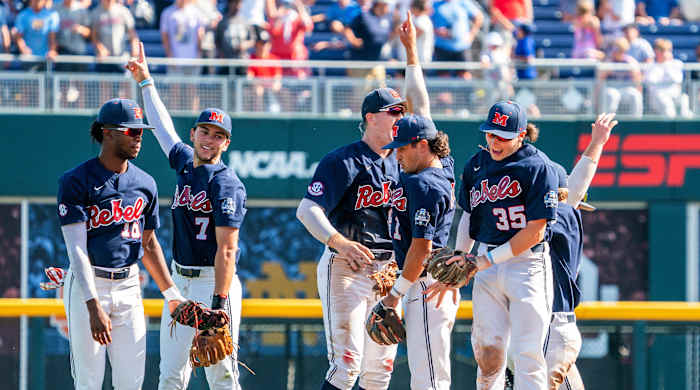 Jun 23, 2022; Omaha, NE, USA; Ole Miss Rebels center fielder TJ McCants (16), shortstop Jacob Gonzalez (7), first baseman Tim Elko (25), second baseman Peyton Chatagnier (1) and left fielder Kevin Graham (35) celebrate after defeating the Arkansas Razorbacks to advance to the final series of the College World Series at Charles Schwab Field.