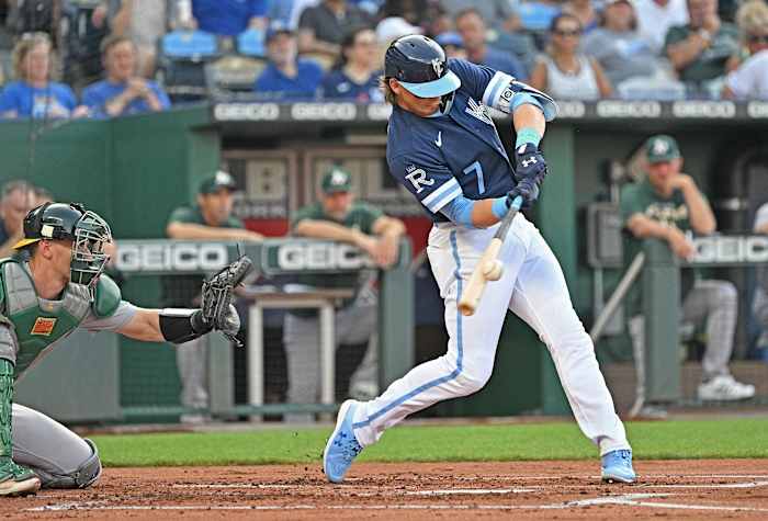 Jun 24, 2022; Kansas City, Missouri, USA; Kansas City Royals shortstop Bobby Witt Jr. (7) triples during the first inning against the Oakland Athletics at Kauffman Stadium. Mandatory Credit: Peter Aiken-USA TODAY Sports