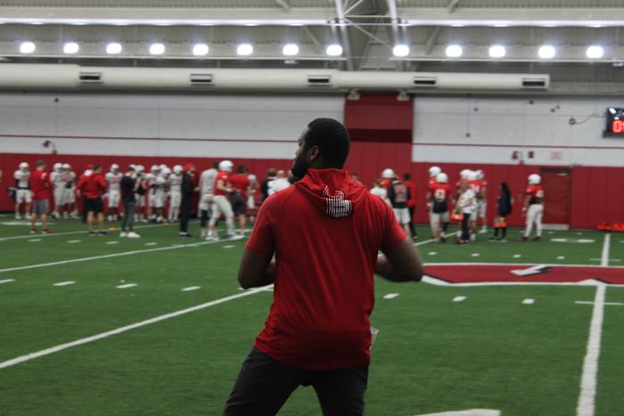 Wisconsin wide receivers coach Alvis Whitted throwing the football during spring practice.