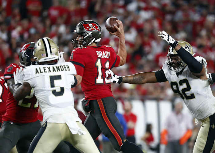 Tampa Bay Buccaneers quarterback Tom Brady (12) throws under pressure from Saints linebacker Kwon Alexander (5) and defensive end Marcus Davenport (92). Mandatory Credit: Kim Klement-USA TODAY