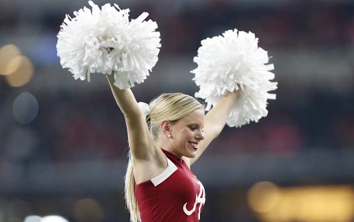 Alabama Crimson Tide cheerleader at a college football game in the SEC with a place in the top 25 rankings on the line.