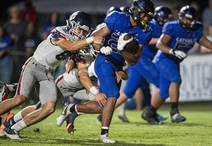 Catholic's Jeremiah Cobb (23) sheds tacklers as he runs into the end zone for a touchdown at Montgomery Catholic Preparatory School in Montgomery, Ala., on Friday, Oct. 15, 2021. Catholic defeated Trinity 52-7.