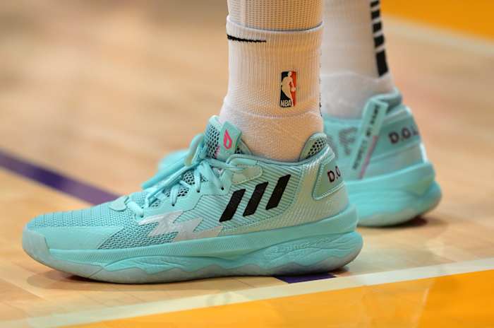 View of blue Adidas Dame shoes.