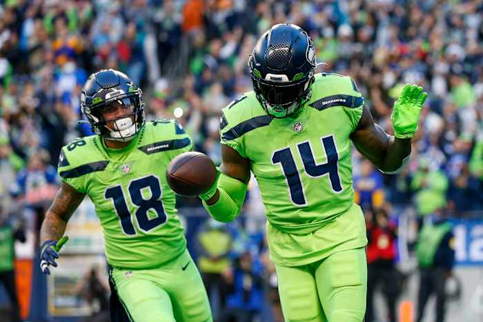 Seattle Seahawks wide receiver DK Metcalf (14) celebrates with wide receiver Freddie Swain (14) after catching a touchdown pass against the Los Angeles Rams during the second quarter at Lumen Field.