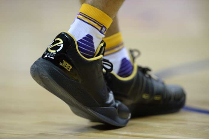 A detailed view of Lonzo Ball's black and gold sneakers.