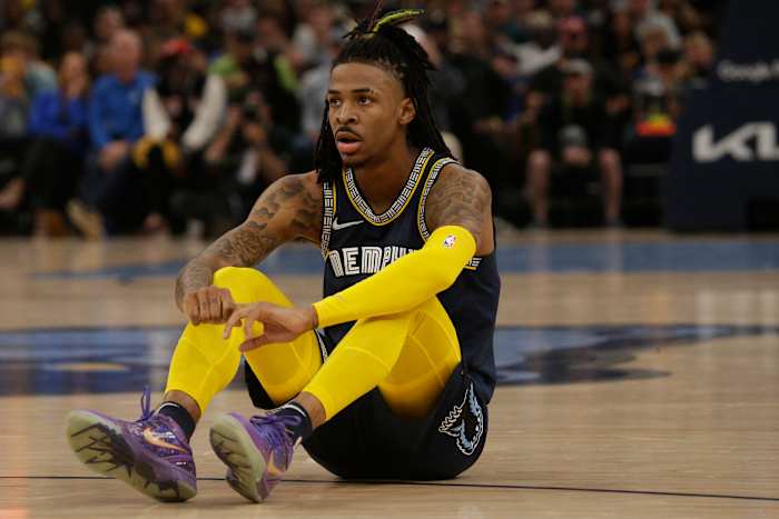 Ja Morant sits on the court during a game.