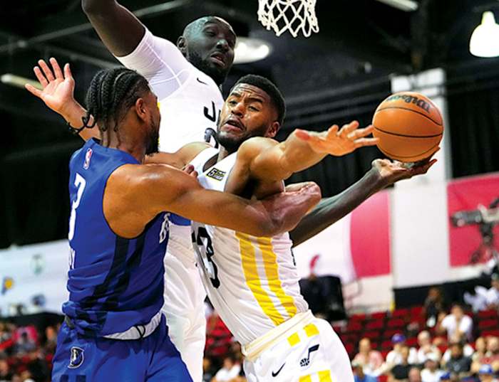Dallas Mavericks guard Jaden Hardy (3) attempts to lob a pass around Utah Jazz guard Tacko Fall (99) and Utah Jazz guard Jared Butler (13) during an NBA Summer League game at Cox Pavilion.