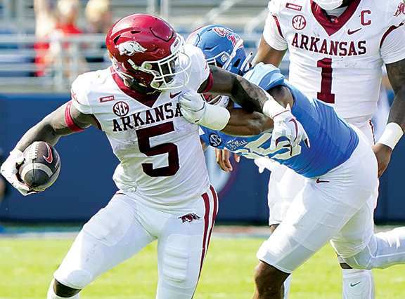 Arkansas Razorbacks running back Raheim Sanders (5) is grabbed from behind by Mississippi Rebels defensive lineman Tavius Robinson (95) at Vaught-Hemingway Stadium.