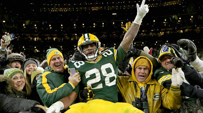 AJ Dillon celebrates scoring his first of two rushing touchdowns with a Lambeau leap.