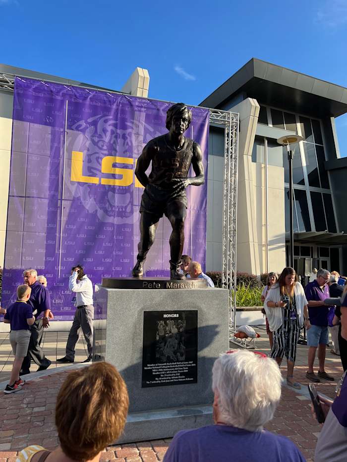 Pete Maravich's statue, posing as his signature behind-the-back pass, is unveiled on July 25, 2022.