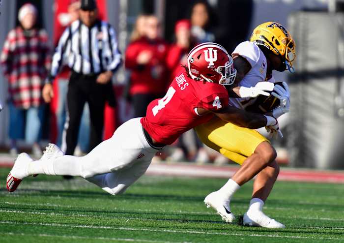 Cam Jones tackles Minnesota Golden Gophers wide receiver Chris Autman-Bell during the first quarter at Memorial Stadium.