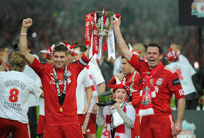 Steven Gerrard and Jamie Carragher pictured holding the League Cup trophy after Liverpool won it in 2012