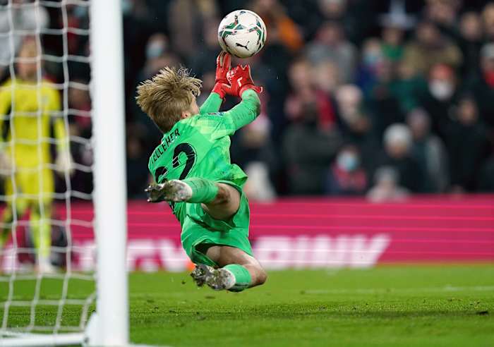 Caoimhin Kelleher pictured saving a penalty in Liverpool's shootout win over Leicester in the 2021/22 EFL Cup quarter-finals