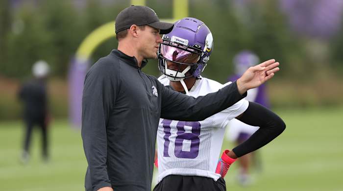 Vikings coach Kevin O’Connell talks with receiver Justin Jefferson at training camp.