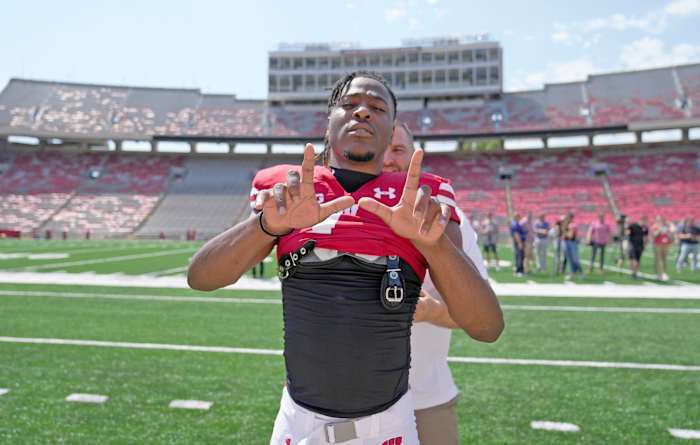 Wisconsin cornerback Jay Shaw posing with his hands in a 'W' at local football media day (Credit: Mike De Sisti / Milwaukee Journal Sentinel / USA TODAY NETWORK)