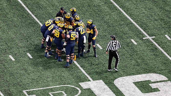 Michigan players huddle during the Wolverines’ spring game