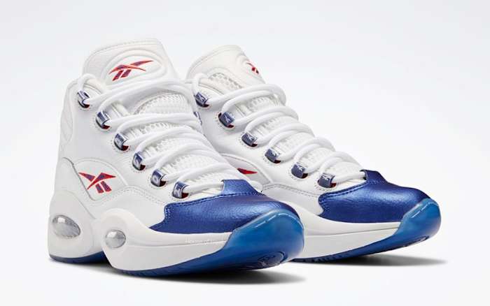 View of white and blue Reebok shoes.