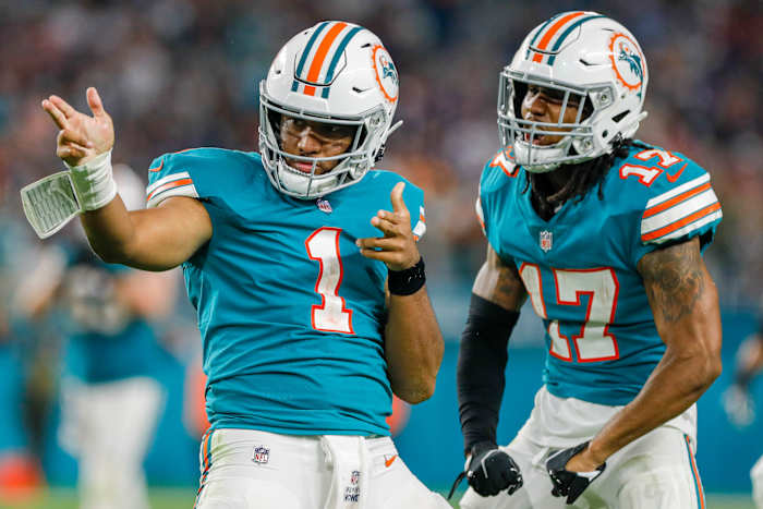 Jan 9, 2022; Miami Gardens, Florida, USA; Miami Dolphins quarterback Tua Tagovailoa (1) reacts with wide receiver Jaylen Waddle (17) after running with the football for a first down against the New England Patriots during the fourth quarter at Hard Rock Stadium. Mandatory Credit: Sam Navarro-USA TODAY Sports