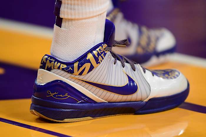 View of white, purple, and gold Kobe shoes.