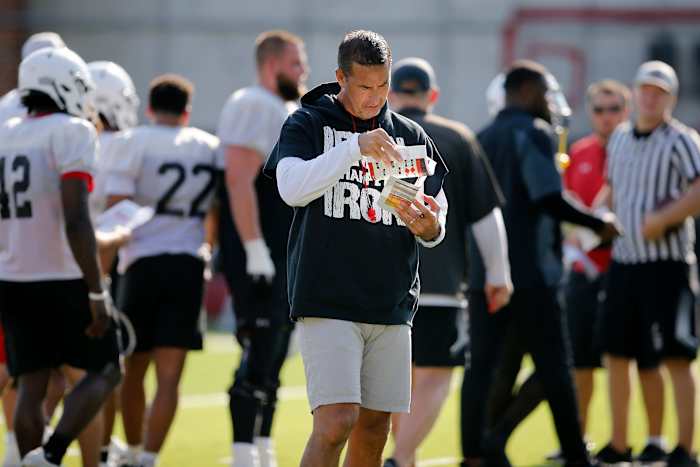 Bearcats head coach Luke Fickell checks notes during the first day of preseason training camp at the University of Cincinnati s Sheakley Athletic Complex in Cincinnati on Wednesday, Aug. 3, 2022. Bearcats Football Camp