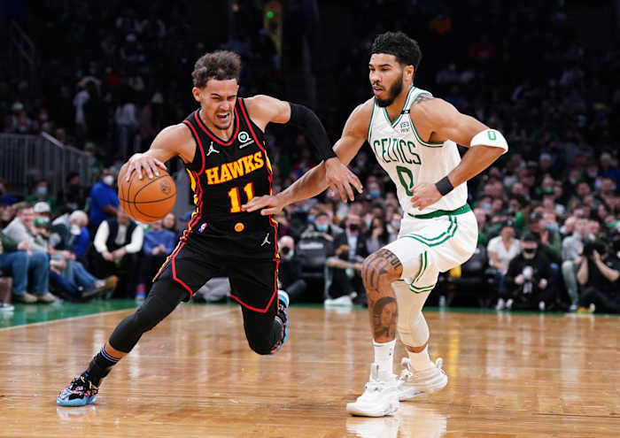 Atlanta Hawks guard Trae Young dribbles past Boston Celtics forward Jayson Tatum.