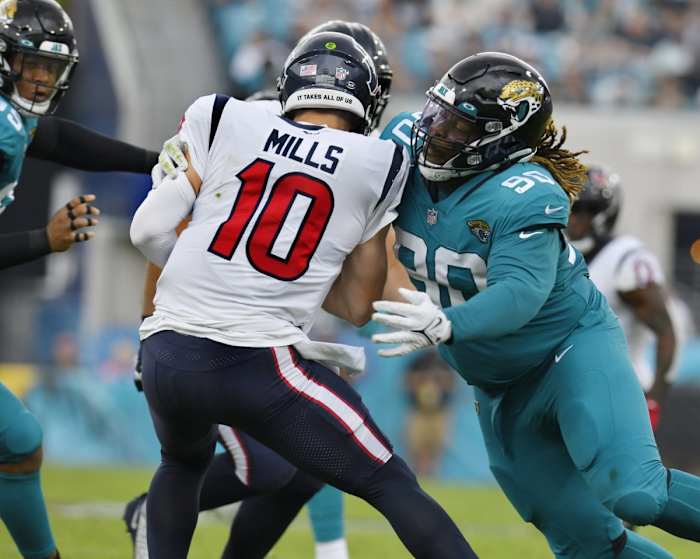 December 19, 2021; Jacksonville Jaguars defensive tackle Malcom Brown (90) sacks Houston Texans quarterback Davis Mills (10). Bob Self/Florida Times-Union / USA TODAY NETWORK