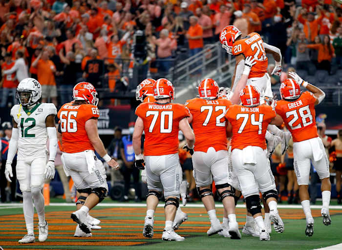 Oklahoma State celebrates a Dominic Richardson (20) touchdown in the third quarter of the Big 12 Championship Game against Baylor last season at AT&T Stadium in Arlington, Texas. jump